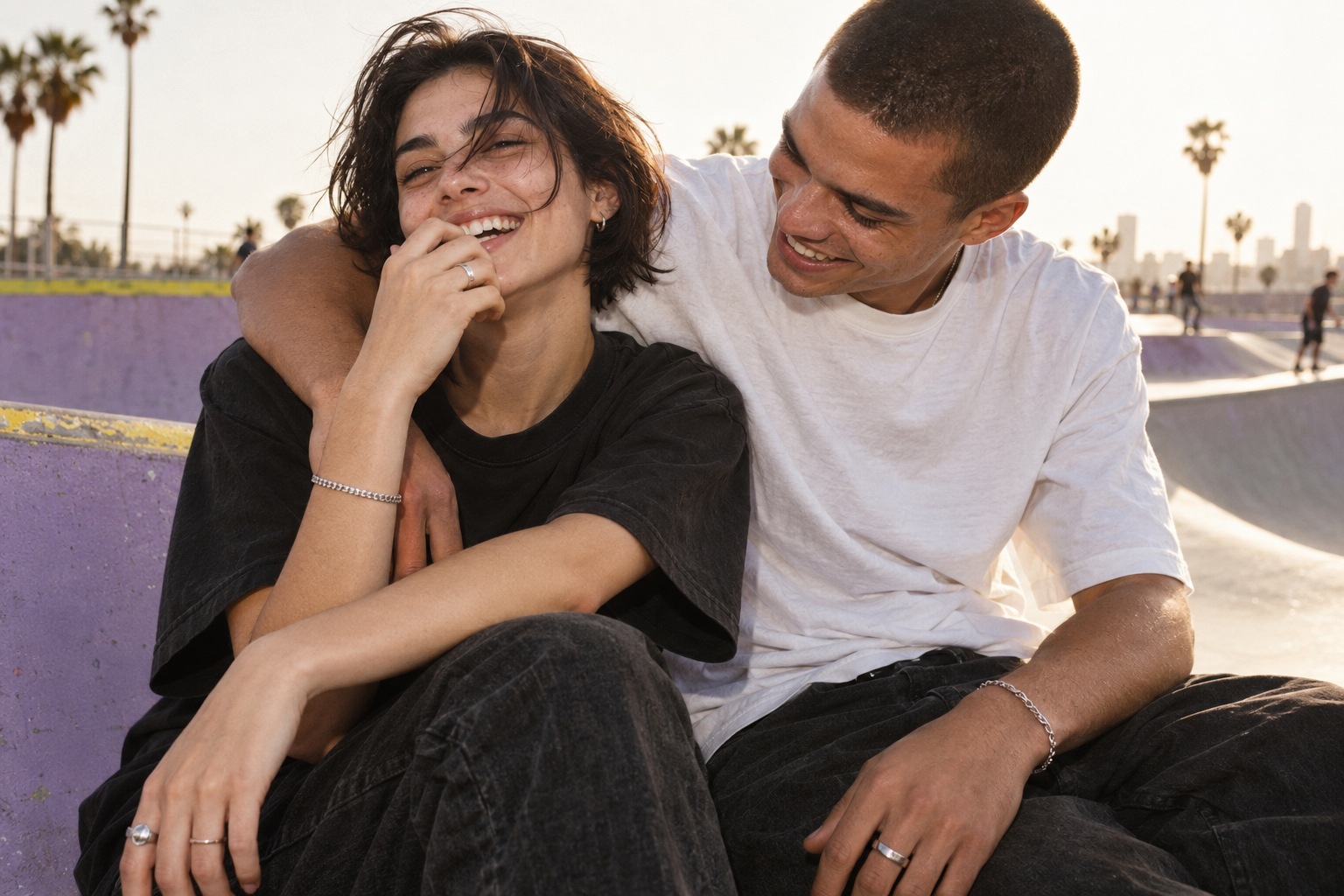 Editorial concept of two adult friends in relaxed streetwear at a lavender skatepark