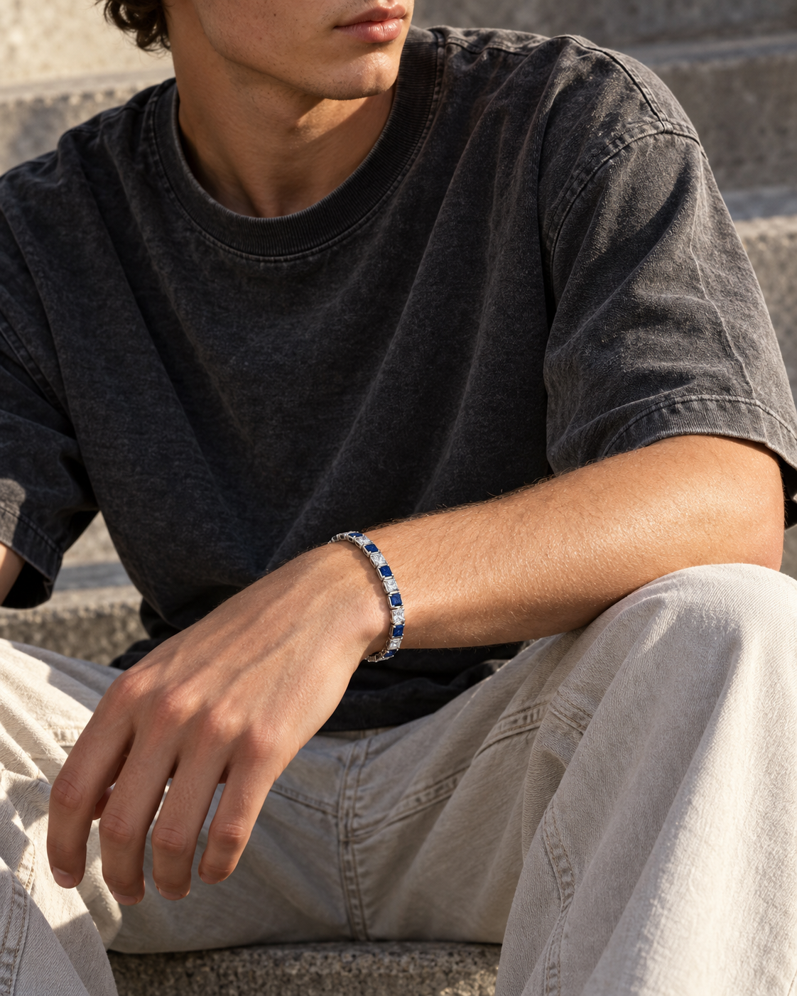 Editorial concept of Midnight blue-and-clear bracelet on a wrist with relaxed streetwear